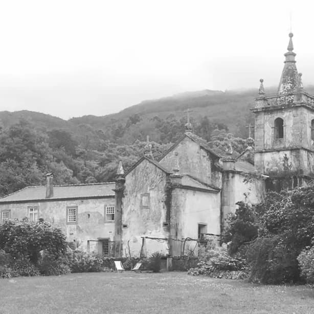 The monastery before its restoration — the weathered façade and bell tower, the grounds overgrown