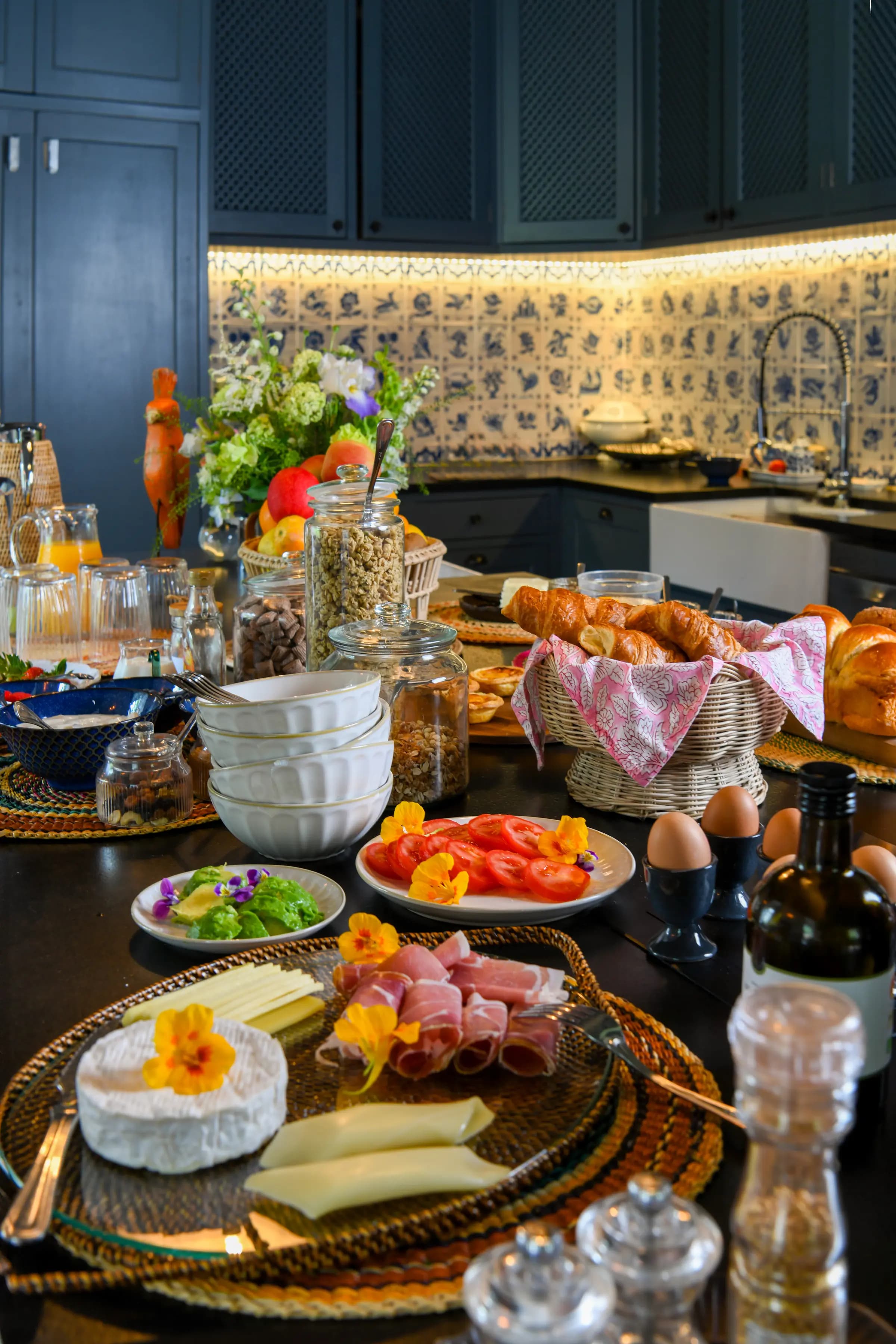 Breakfast laid on the Blue Kitchen table — bread, fruit, eggs