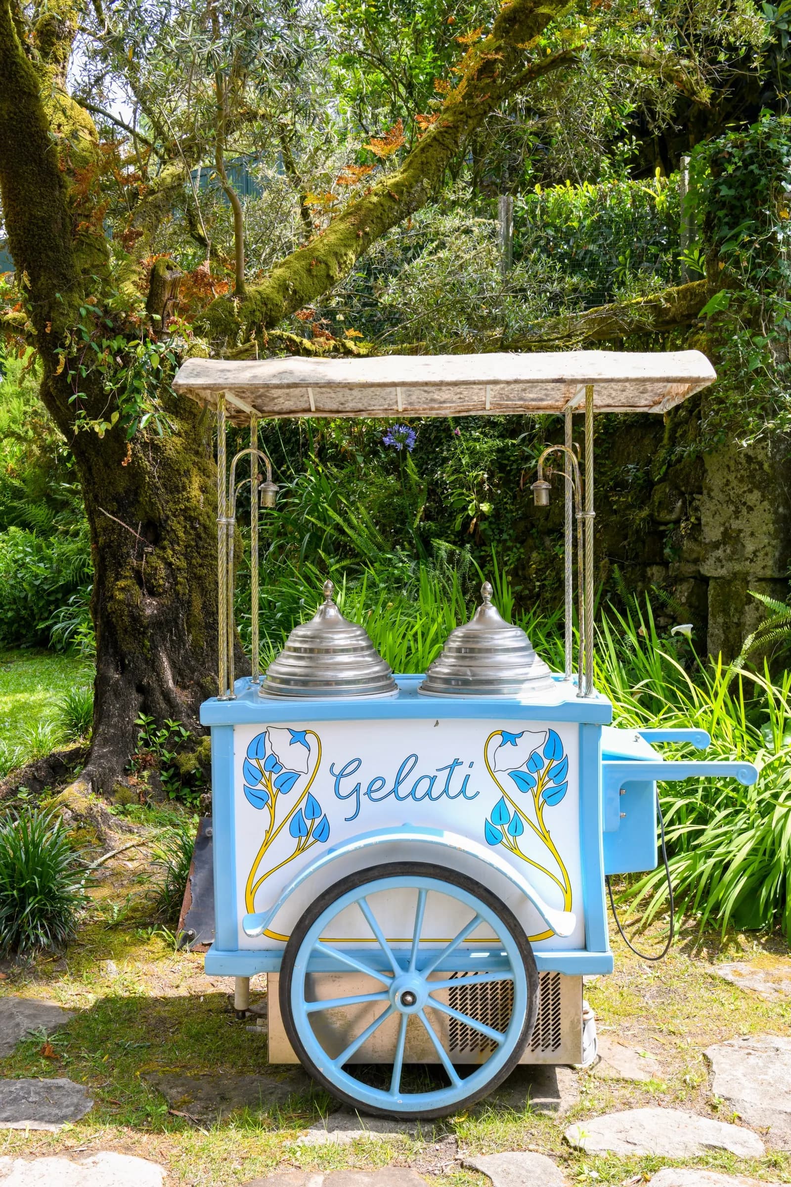 The azulejo-blue gelato cart in the café garden