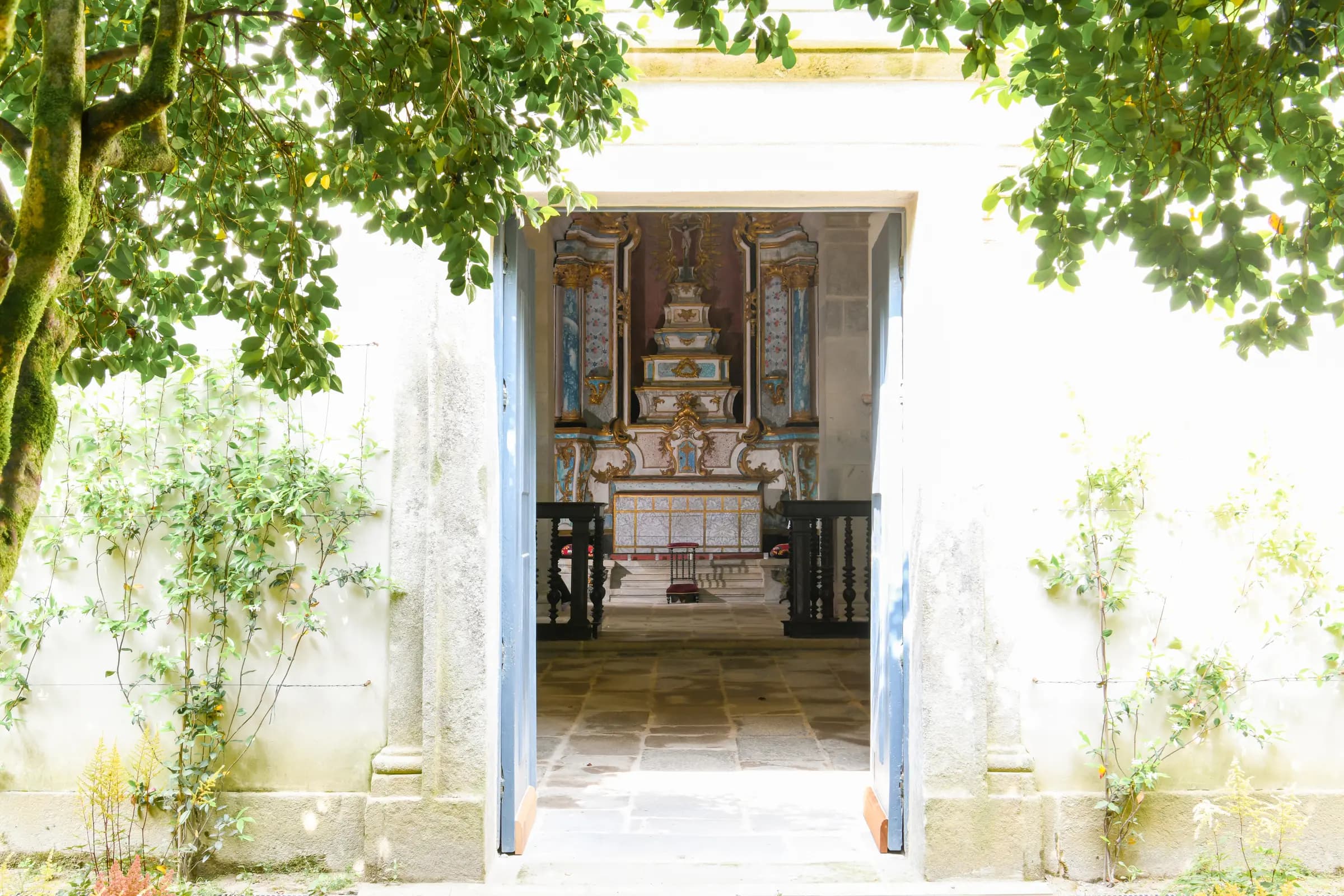 The church door open to the garden, the altar glowing within