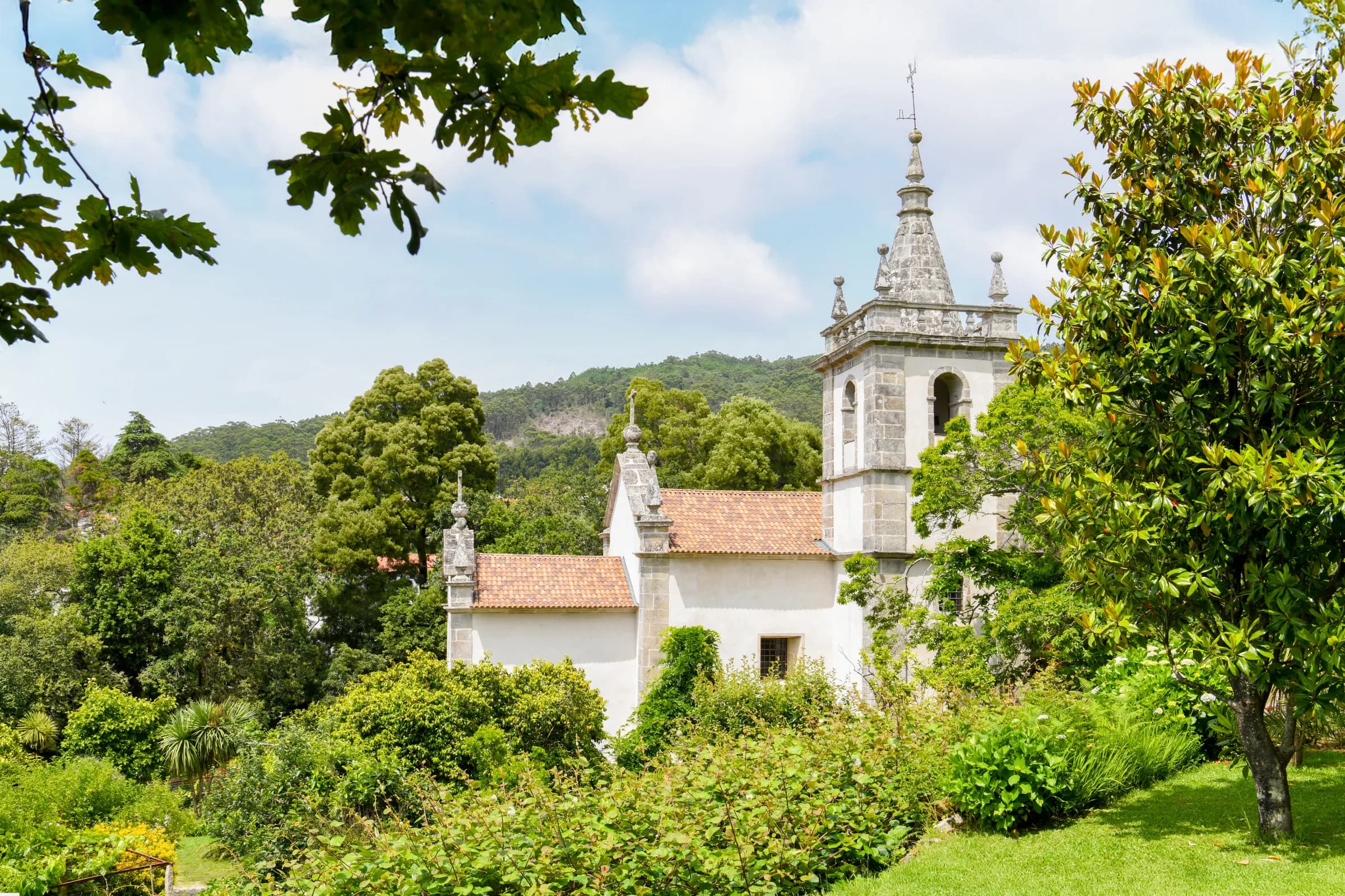 The church tower rising over the gardens of the estate