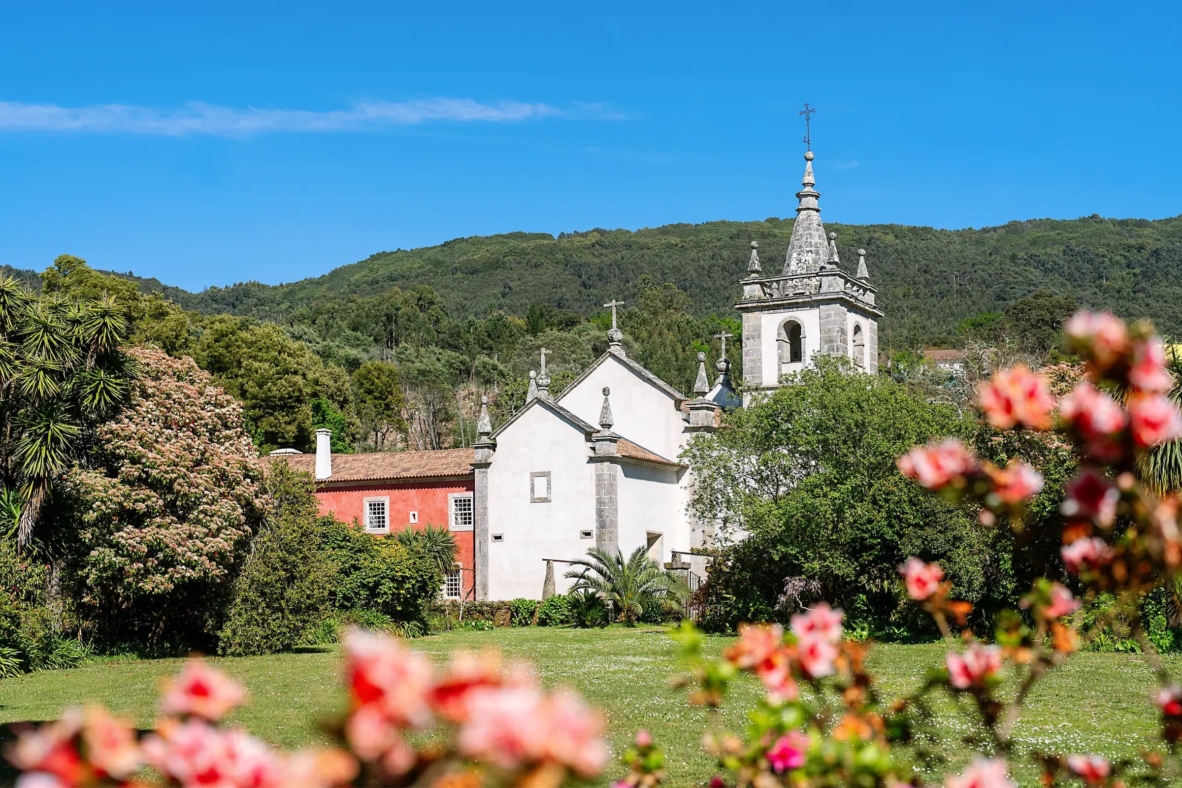 The estate and church towers seen across flowering gardens