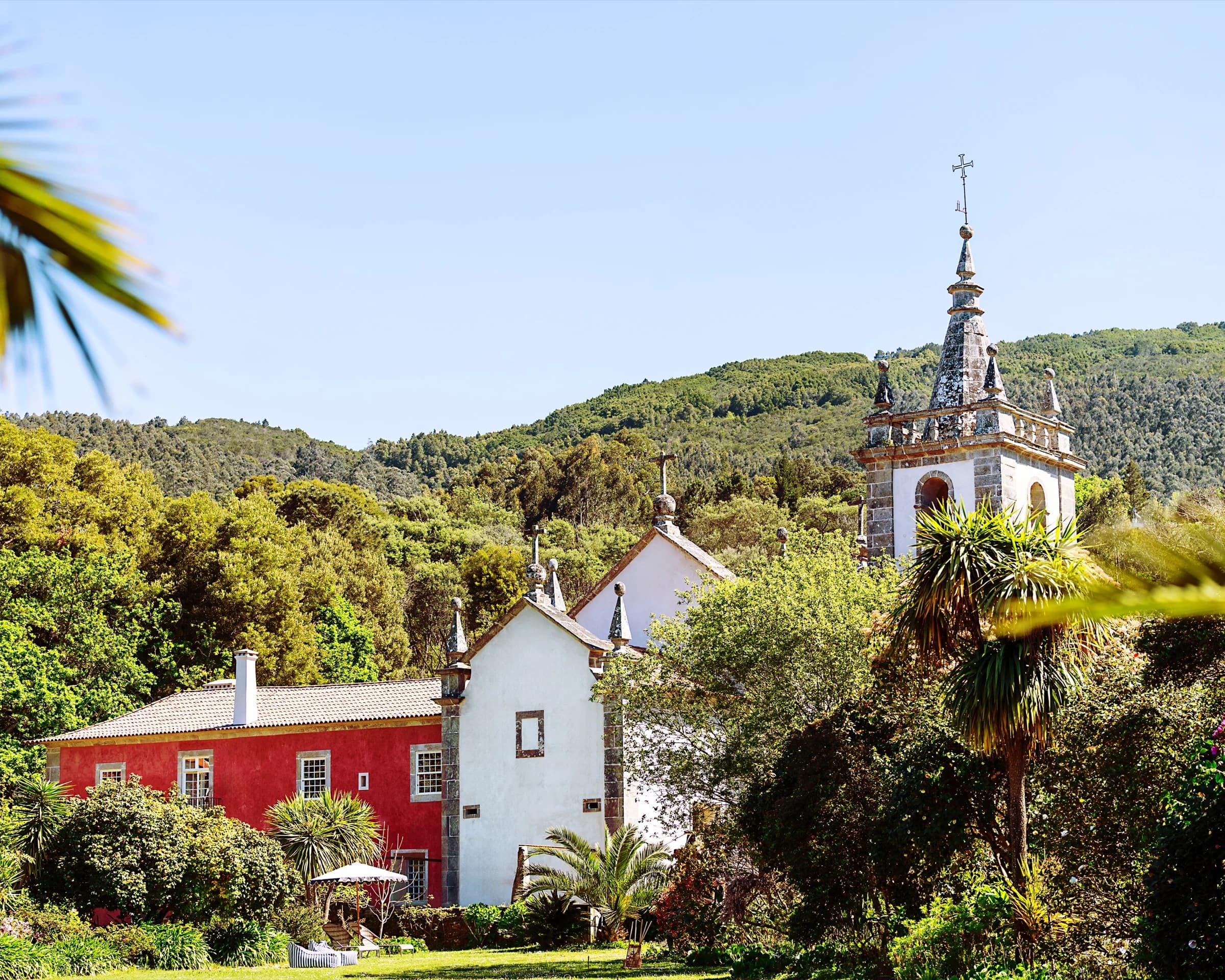 The estate, church and red house between gardens and mountain