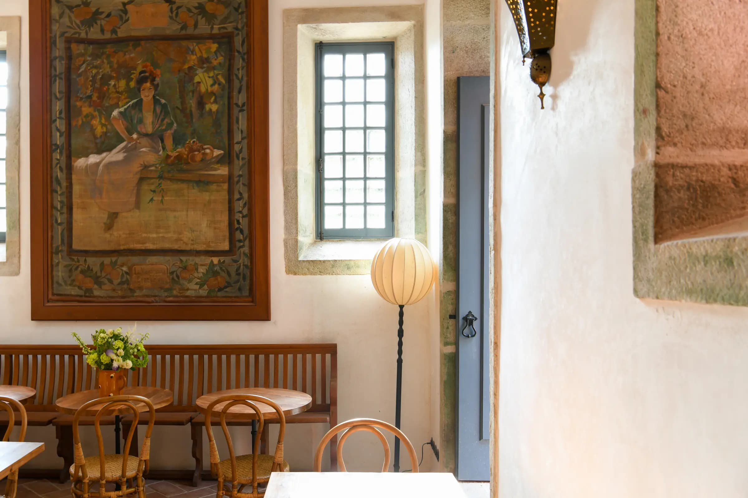The Magnolia dining room, bentwood chairs and painted mural