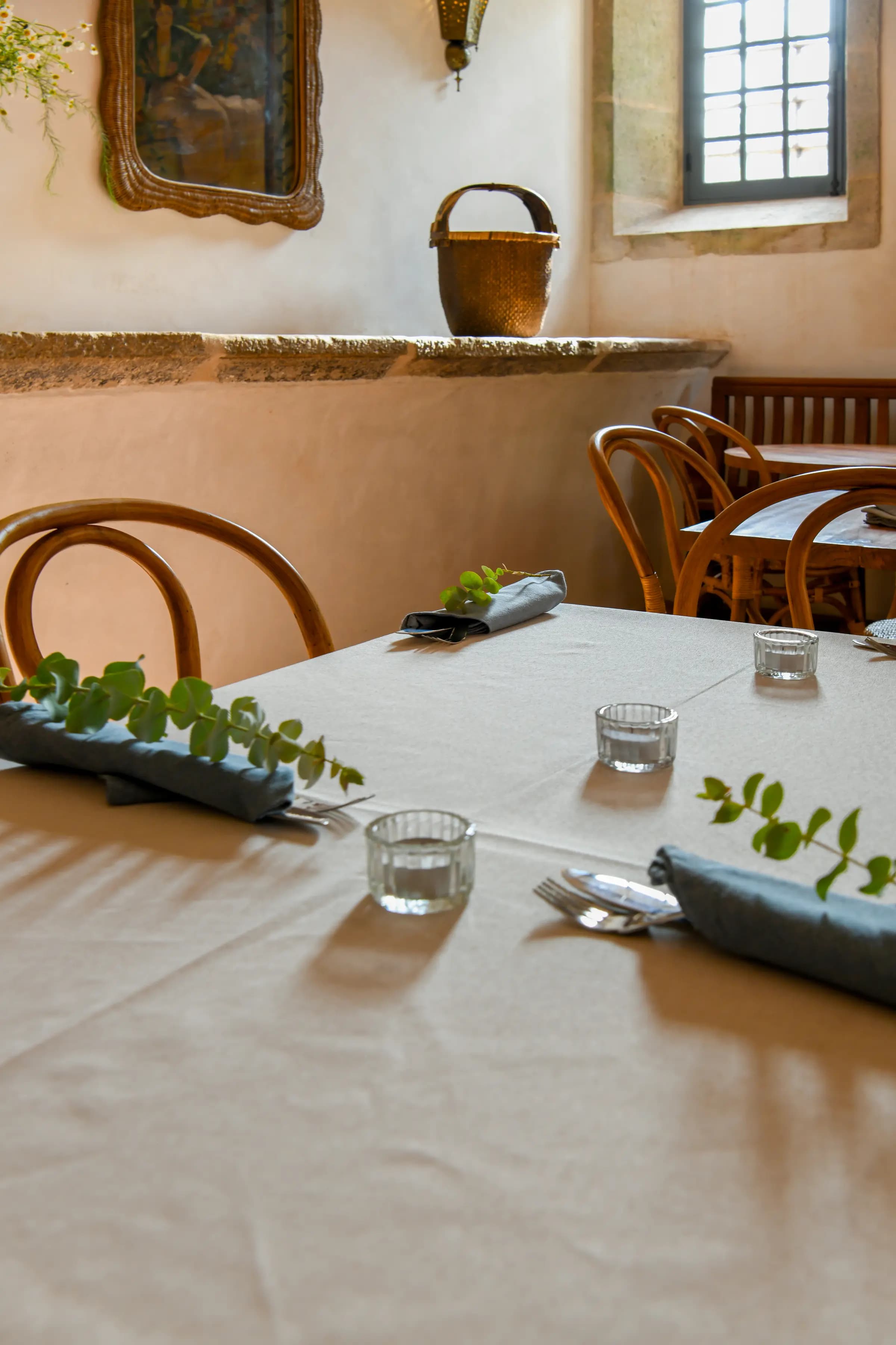 A table set at Magnolia — linen, glass and garden greens