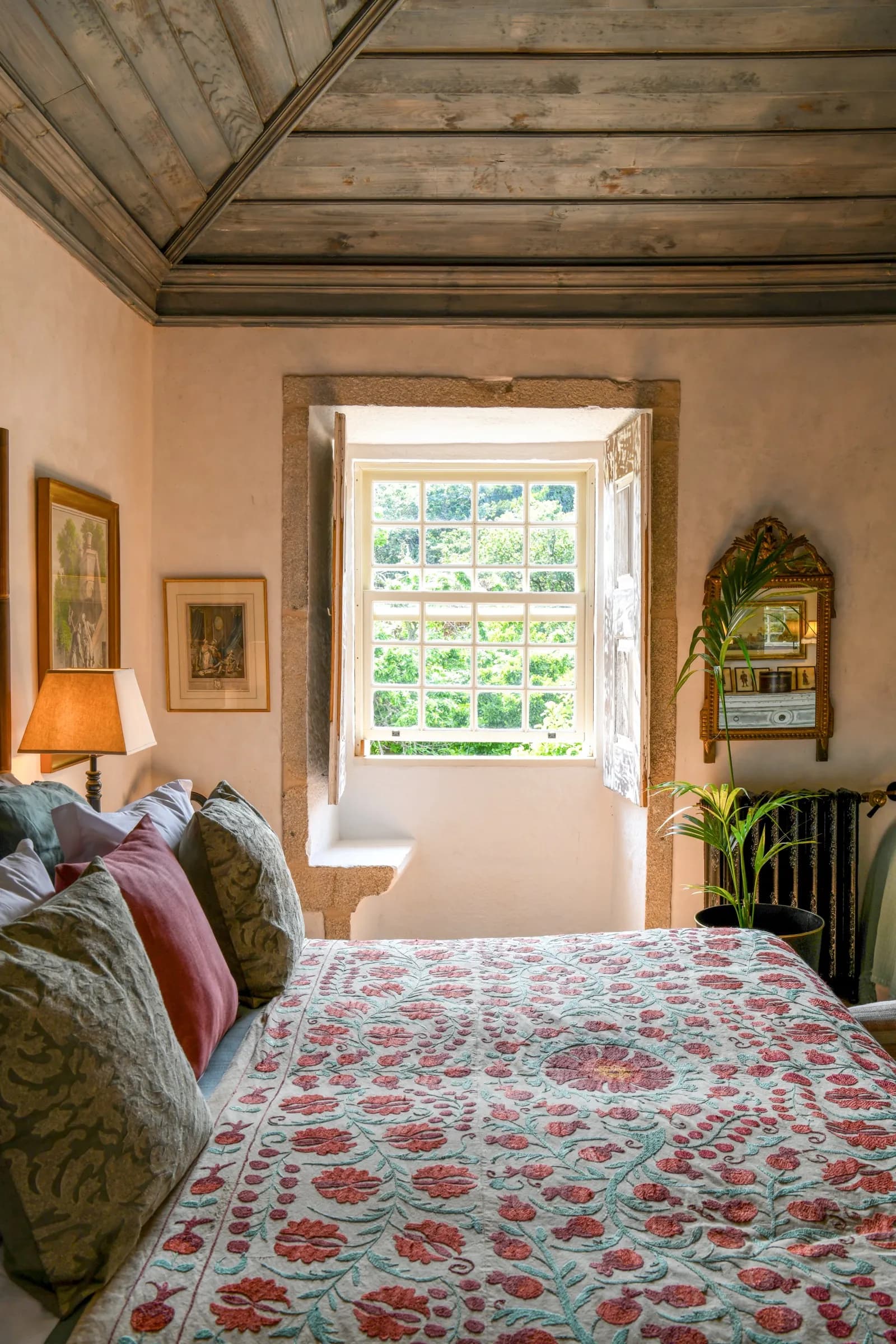A suite with timber-beamed ceiling and a window onto the gardens