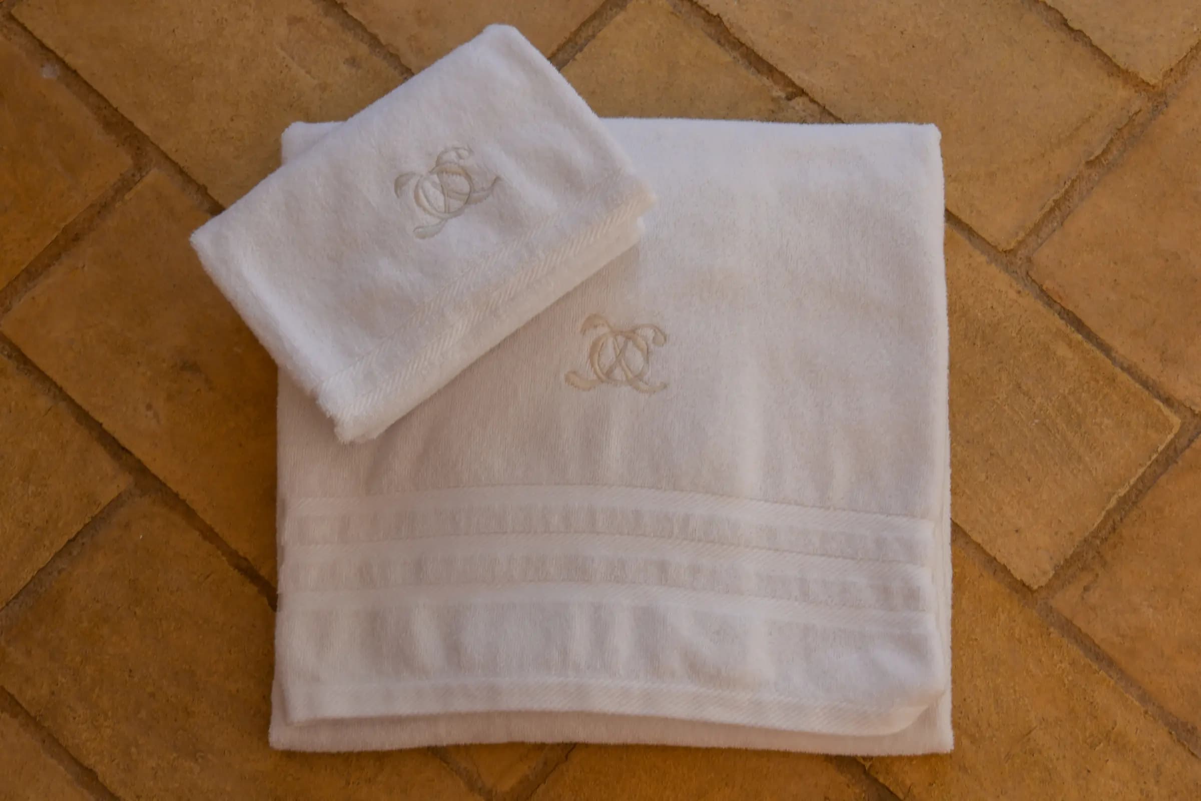 Monogrammed towels folded for a treatment